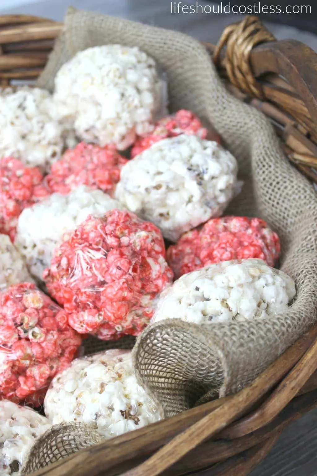 Red white and blue popcorn balls in cute large basket with burlap liner. {lifeshouldcostless.com}