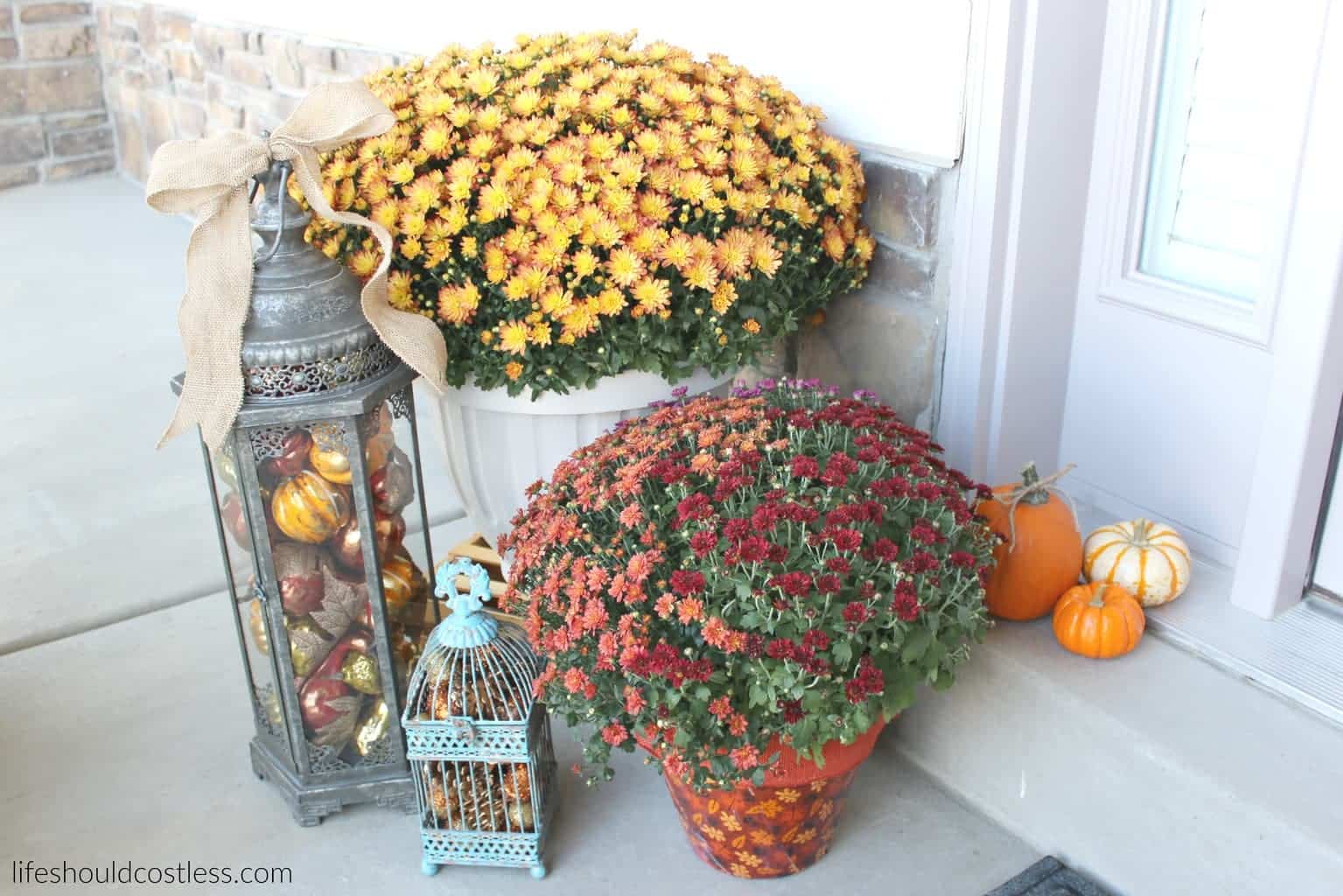 Rustic fall porch decor reveal. See this post and many more popular decor pins at lifeshouldcostless.com. Lantern filled with fall decor.